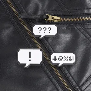 Retro pixelated speech bubble enamel pins with symbols pinned on black leather jacket