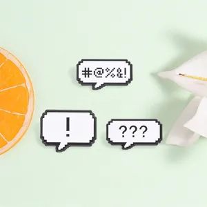 Detail view of retro pixel speech bubble pins with exclamation and question marks