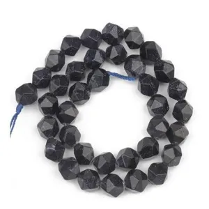 Faceted dark blue sandstone loose beads detail, sparkling DIY jewelry making accessory.