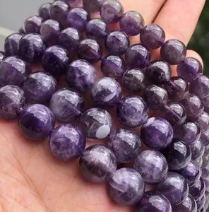 Close-up detail of purple crystal gemstone loose beads for DIY jewelry making and bracelets.