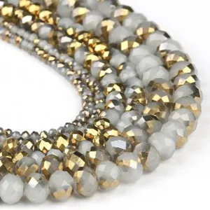 Detailed view of crystal faceted wheel beads, showing exquisite cut and grey gold color.
