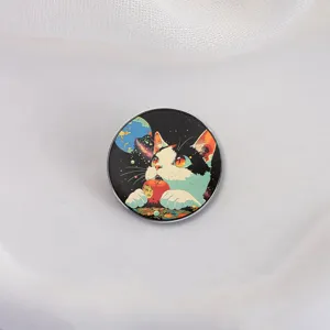 Circular enamel pin featuring a cute space cat eating an apple on white background.