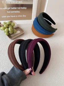 Detailed view of fashionable multi-colored wide ribbed headbands for high-crown styling