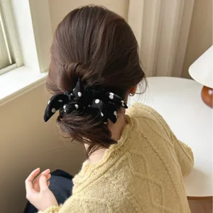 Elegant black and white polka dot bow scrunchie hair tie for stylish ponytail styling