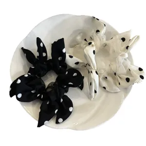 Elegant polka dot bow hair scrunchies set in black and white for ponytail styling.
