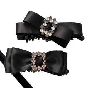 Elegant black satin bow hair clips with decorative square rhinestone buckles for women
