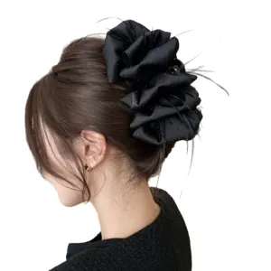 Elegant black oversized hair claw clip with rhinestones and feathers on white background