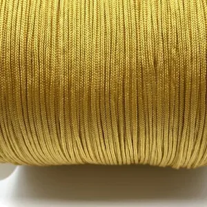 Golden braided cord detail shot, smooth jade thread for DIY craft, bracelet and necklace making.