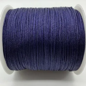 Dark purple nylon craft cord detail on white spool for DIY handmade jewelry weaving projects.