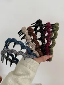 Multi-colored retro yarn-wrapped wavy headbands with anti-slip teeth shown in hand.