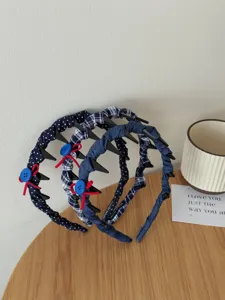 Detail view of navy blue fabric-covered headbands with non-slip tooth combs