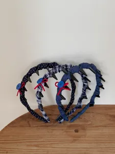 Detail of navy blue polka dot and plaid headbands with anti-slip teeth and bows