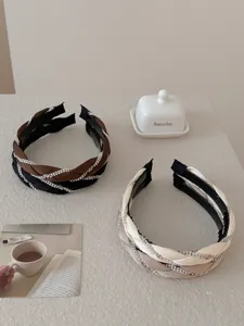 Elegant braided headbands with sparkling rhinestones in black, brown, and cream tones