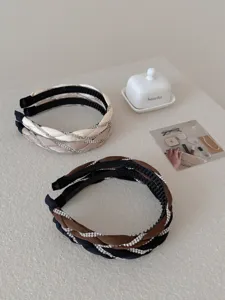 Detailed view of braided headbands with sparkling rhinestones in elegant lifestyle setting
