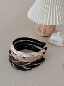 Close-up of elegant braided headbands with sparkling rhinestones in multiple colors