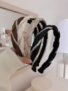 Close-up of elegant braided rhinestones headbands in four neutral colors.