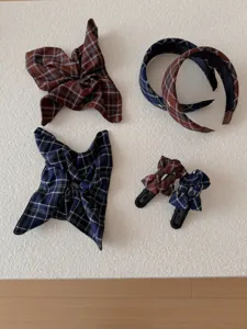 Detailed display of vintage plaid headbands, scrunchies, and bow hair clips in navy and brown