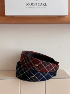 Close-up detail of vintage academic style plaid wide headbands in red and blue