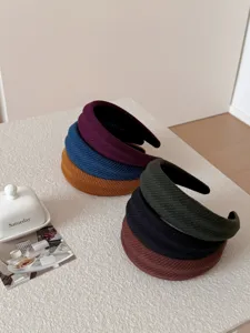 Detailed macro view of solid color wide headbands with striped texture for fall and winter