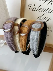 Detailed close-up of knitted wide headbands with amber resin buckles in various colors