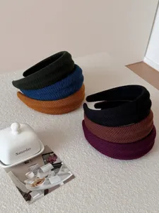 Close-up of ribbed texture and multiple colors of padded headbands on textured table