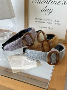 Close-up detail of soft knitted headbands with decorative amber resin buckles