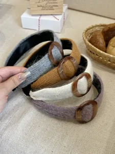 Close-up of knitted wide headbands with resin ring detail in assorted autumn colors