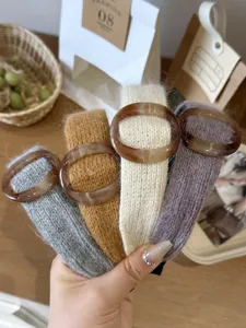 Detail of knitted winter headbands with tortoiseshell pattern buckles in various colors