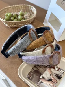 Group of knitted wide headbands with decorative amber-colored circular rings in assorted colors
