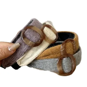 Set of four knitted wide-brimmed headbands with stylish brown marbled acrylic rings