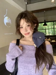 Asian model wearing a stylish navy blue polka dot bow scrunchie hair tie in a cafe