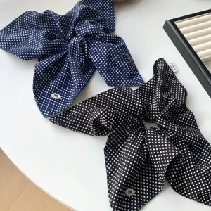 Elegant polka dot scrunchie scarves in navy and black for versatile hair styling