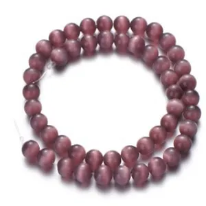 Close-up detail of purple cat eye beads strand, smooth matte finish, DIY jewelry making.