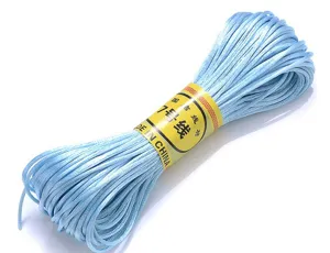 Detail shot of light blue Chinese knotting cord, fine woven texture for DIY handmade bracelets.