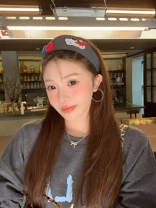Trendy wide knit headband with cute dog embroidery and buttons shown on model.