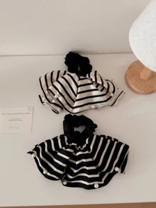 Detail of black and white striped fabric scrunchies with pearl edge embellishments