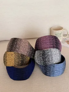 Detailed close-up of various colorful knitted wide-brim gradient headbands for women