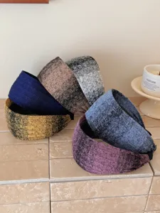 Detailed macro view of various gradient colored knitted wide headbands for a retro style
