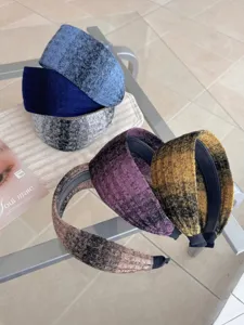 Detail shot of stylish knitted wide headbands featuring diverse gradient color textures