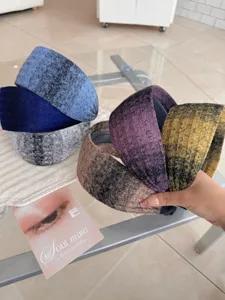Close-up of knitted wide-edge headbands in various gradient colors and soft textures.