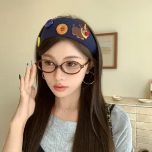 Stylish blue wide knitted headband featuring cute embroidered dog and large colorful buttons