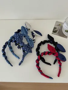 Collection of denim polka dot bow headbands with braided rabbit ear design.