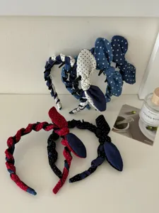 Detailed view of polka dot denim bow headbands with braided design in various colors
