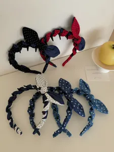 Detailed view of braided denim headbands with polka dot bows in various assorted colors