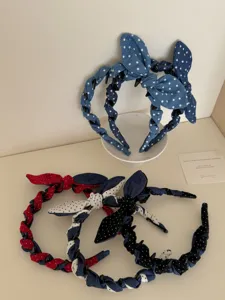 Detailed macro view of Korean style denim polka-dot bow headbands with twisted design