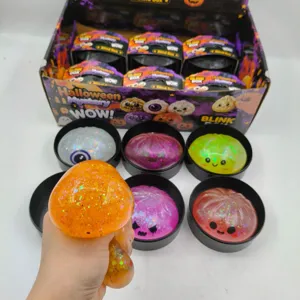 Macro shot of a glittery orange Halloween bun stress toy being squeezed