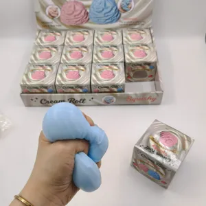 Close-up of blue cream roll squishy toy being squeezed for stress relief demonstration