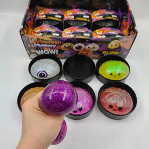 Close-up of a purple glitter Halloween squeeze toy being squeezed for stress relief