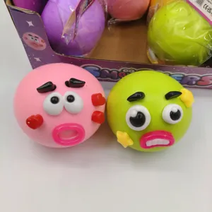 Detailed view of colorful pink and green cartoon face squishy stress relief balls