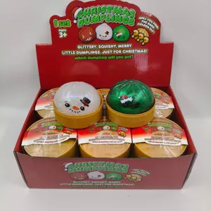 Coffret de jouets squishy dumplings de Noël présentés dans une boîte de fête pailletée